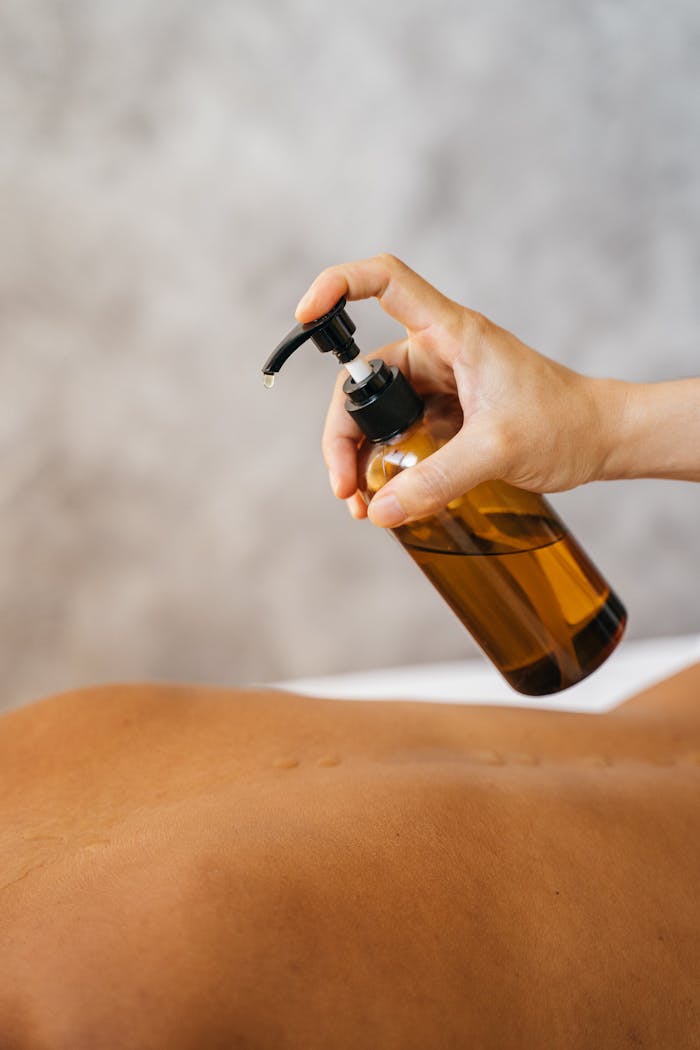programs-02 A relaxing massage with oil, showcasing a therapist's hand in a soothing spa setting.